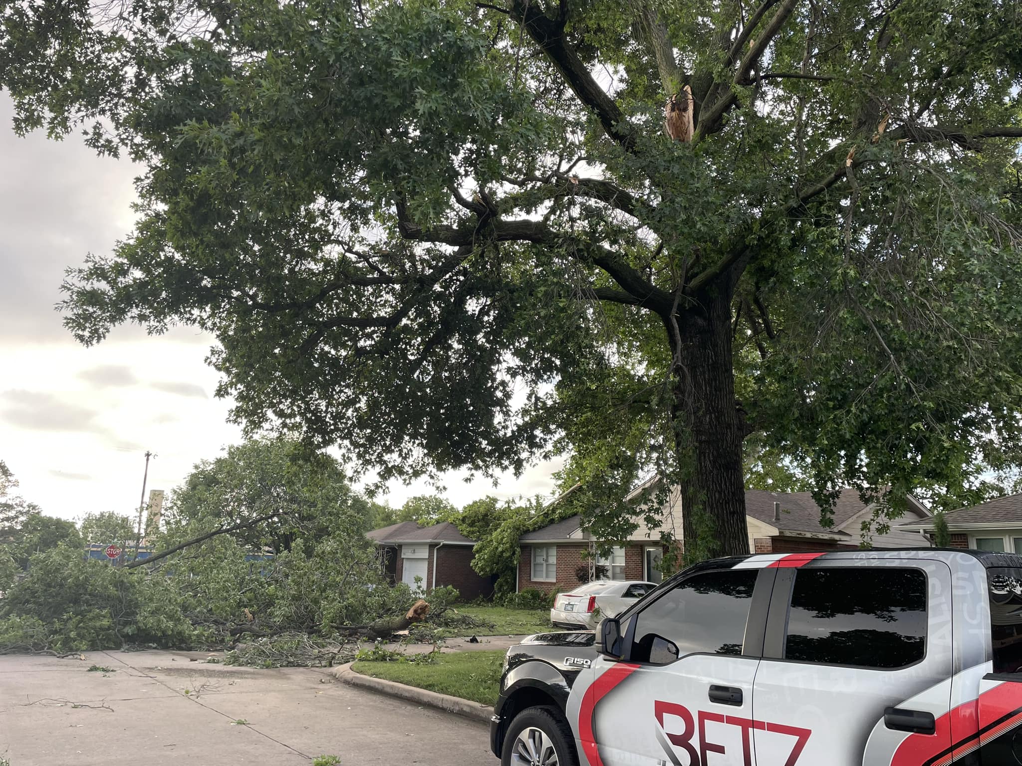 Betz Exterior Solutions parked in the street surrounded by storm damage